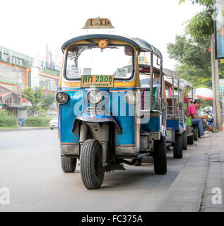 rickshaws parked on the road near the curb Stock Photo