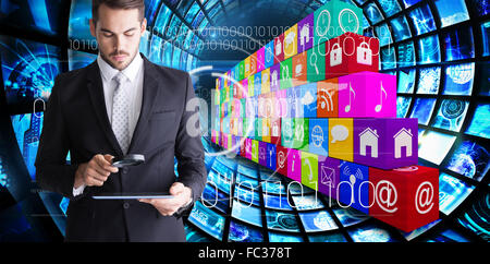 Composite image of concentrated businessman using magnifying glass Stock Photo