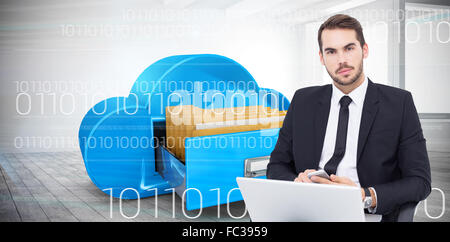 Composite image of cheerful businessman with laptop using smartphone Stock Photo