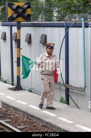 dispatcher on the platform shows the green flag Stock Photo