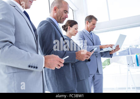 Business colleagues using their multimedia devices Stock Photo