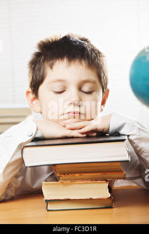 Bored caucasian boy in classroom Stock Photo