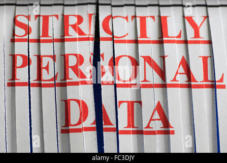 'STRICTLY PERSONAL DATA' paper through a shredder. Stock Photo