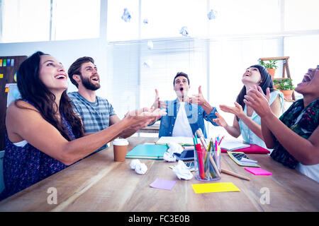 Creative business people throwing paper in the air Stock Photo