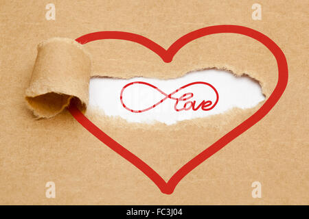 Endless Love concept with infinity symbol appearing behind torn brown paper. Stock Photo