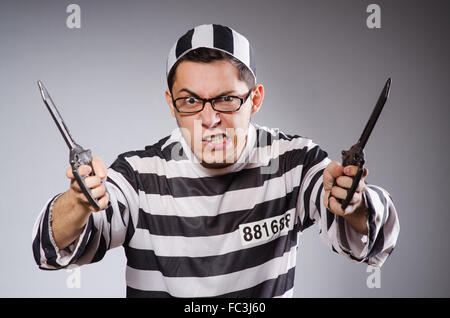 Funny prisoner with knuckles isolated on gray Stock Photo