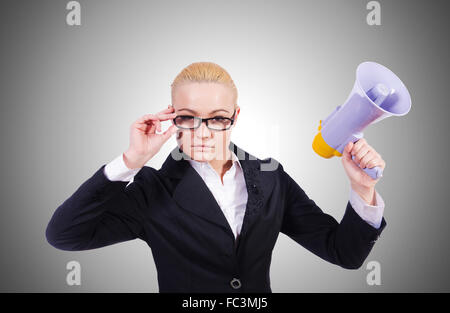 Woman businesswoman with loudspeaker against the gradient Stock Photo