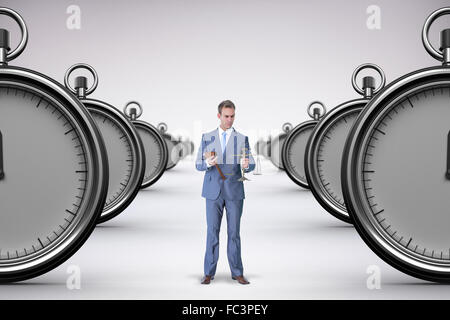 Composite image of businessman holding scales of justice Stock Photo