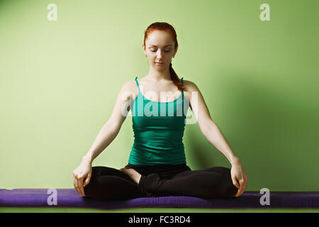 Relaxed woman in lotus position Stock Photo