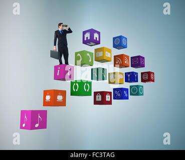Composite image of businessman using binoculars while holding a briefcase Stock Photo
