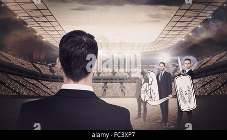 Composite image of rear view of businessman in suit standing Stock Photo