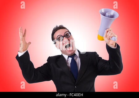 Young businessman with loudspeaker against the gradient Stock Photo