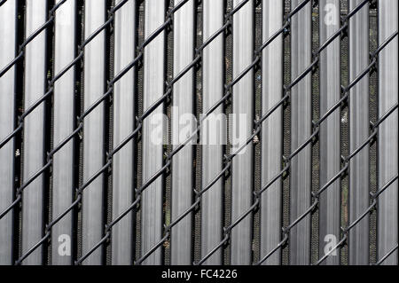 Close up of metal fence with vertical and oblique lines Stock Photo