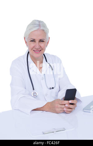 Thinking woman doctor phoning with her smartphone Stock Photo