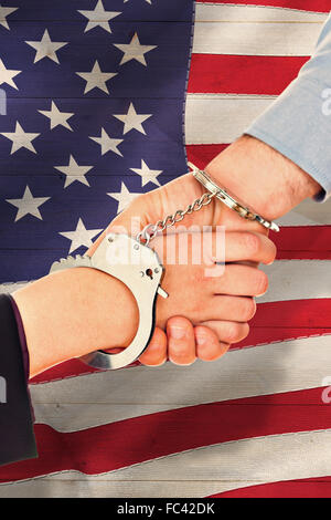 Composite image of business people in handcuffs shaking hands Stock Photo