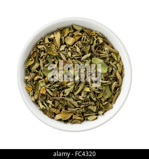 Dried Oregano Leaves in a Ceramic Bowl. The image is a cut out, isolated on a white background. Stock Photo