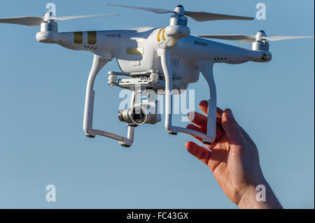 Phantom 3 Professional drone or quadcopter with wide angle video camera in flight. Stock Photo