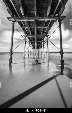 Monochrome long exposure capture under the pier at Saltburn on Sea Stock Photo