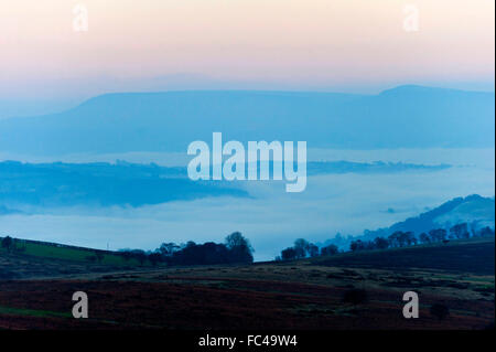 Builth Wells, Powys, Wales, UK. 20th January, 2016. View towards Hay Bluff and The Black Mountains from the Mynydd Epynt moorland near Builth Wells, Powys, Wales. The sun sets on a very cold day in Powys with temperatures below zerro degrees celsius. Credit:  Graham M. Lawrence/Alamy Live News Stock Photo