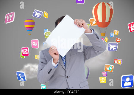 Composite image of businessman holding blank sign in front of his head Stock Photo