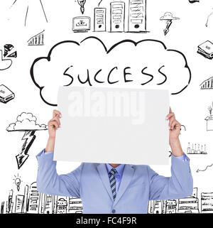 Composite image of  portrait of a businessman hiding his face behind a blank panel Stock Photo