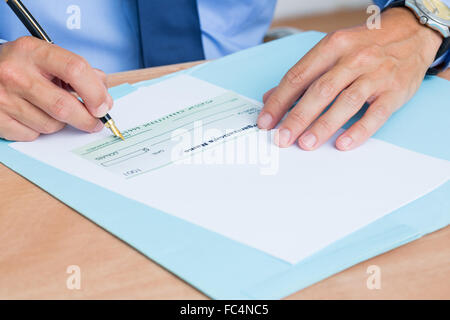 Businessman writing a contrat before signing it Stock Photo