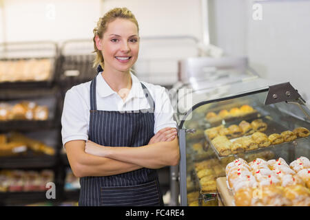 Portrait of a smiling blonde baker with arm crossed Stock Photo