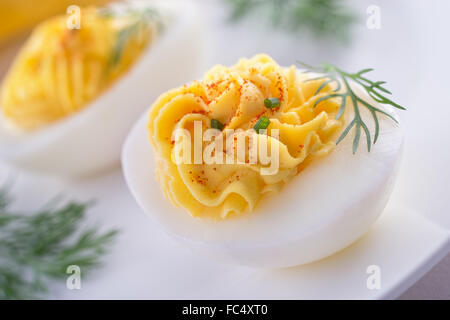 Delicious deviled eggs with paprika, chive, and dill garnish. Stock Photo