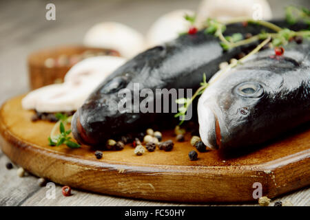 Raw seabass fish on the wooden board Stock Photo