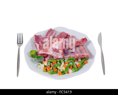 raw meat and vegetables on a plate Stock Photo