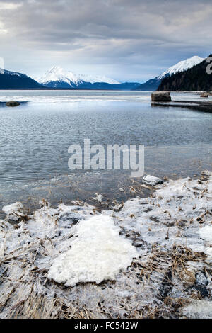 Dark storm clouds moving in over the Chilkat Inlet near Haines Alaska in winter with ice and open water. Stock Photo