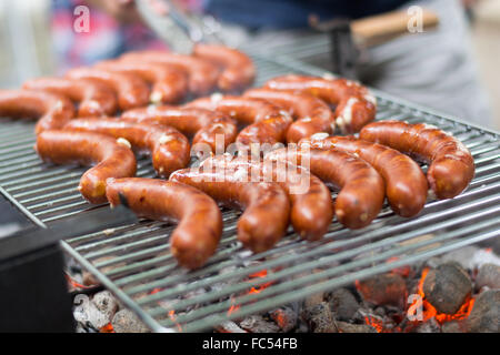 Sausages are grilled on charcoal grill Stock Photo
