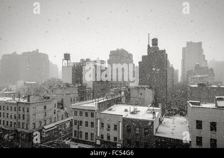 Winter in New York Chelsea neighborhood. Black & White View of New York City during a snowfall, with rooftops and water towers Stock Photo