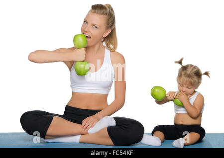 Family trains the weights of green apples Stock Photo