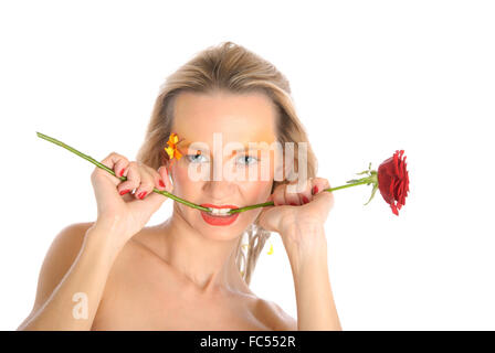 Young woman bites flower stalk Stock Photo