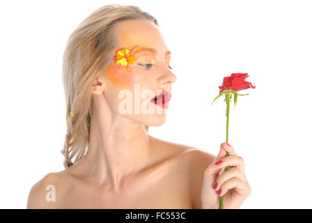 Young woman bites red flower Stock Photo
