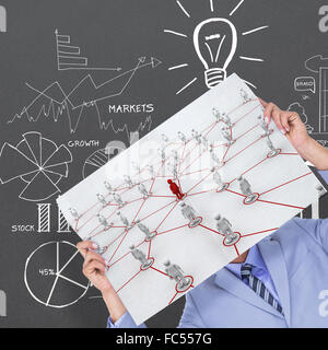 Composite image of portrait of a businessman hiding his face behind a blank panel Stock Photo