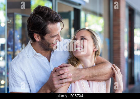 Smiling man putting arm around his girlfriend Stock Photo