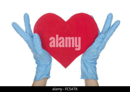 Hands in blue medical gloves keep heart Stock Photo