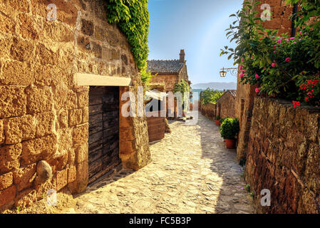 Sunny narrows on a summer day in an old Italian town Stock Photo