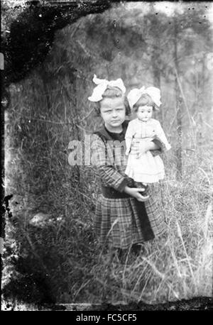 Little girl with baby doll about 1900. Stock Photo