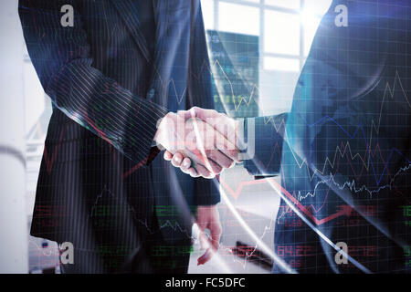 Composite image of business people shaking hands Stock Photo