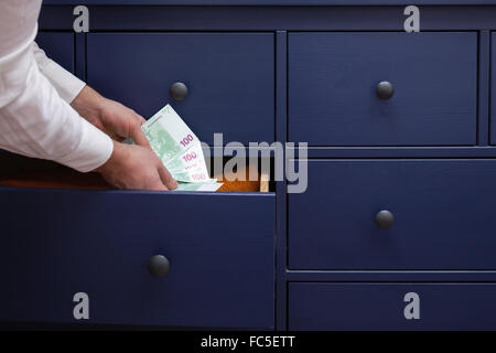 stash for a rainy day due to problems at work and in the economy Stock Photo
