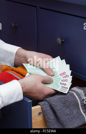 stash for a rainy day due to problems at work and in the economy Stock Photo