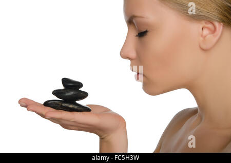 beautiful woman holding black stones on palm Stock Photo