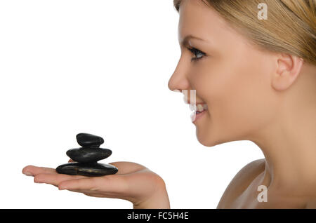 beautiful woman holding stones on palm Stock Photo