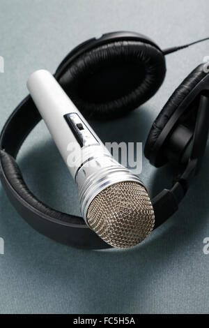 Microphone and ear-phones on a table Stock Photo