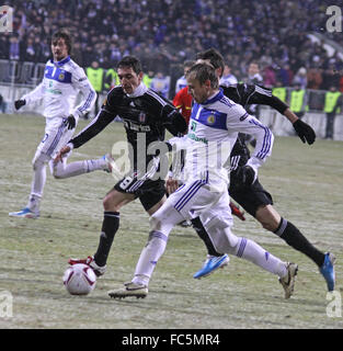 KYIV, UKRAINE - FEBRUARY 24: Oleg Gusev of Dynamo Kyiv (in white) fights for a ball with Besiktas players during their UEFA Europa League game on February 24, 2011 in Kyiv, Ukraine Stock Photo