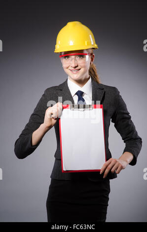 Construction worker in helmet against gray Stock Photo