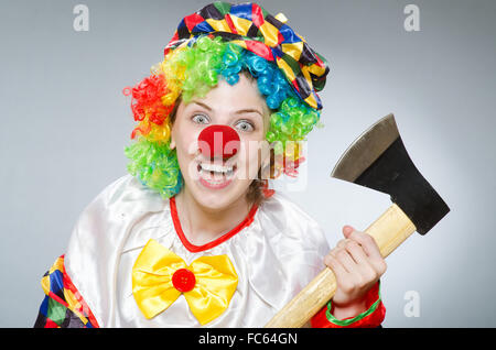 Clown with axe in funny concept Stock Photo